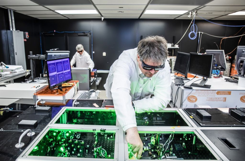 CEO and founder Bjorn Manuel Hegelich aligning laser beams within a laser system at TAU's facility in Austin, Texas.