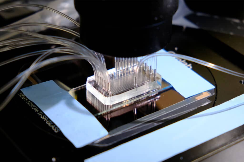 Workcell with a microfluidic chip testing thousands of AI designed proteins.